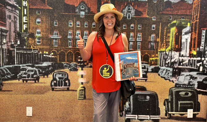 Tour guide posing with their guide book for Colorado Springs Historic Walking Tours in Colorado Springs, Colorado.