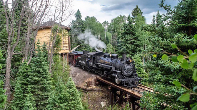 Cumbres and Toltec Scenic Railroad Train going past the Cresco Water Tower between Chama, NM and Cumbres, CO.