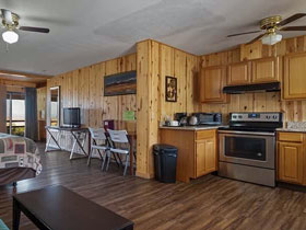 Inside view of deluxe king room with king size bed, pull-out sofa and full kitchen at Great Sand Dunes Lodge in Alamosa, Colorado.