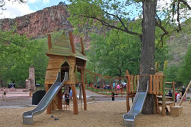 Kids fort playground with slides, swings, splash pads and picnic area at LaVern Johnson RV Park and Campground in Lyons near Rocky Mountain National Park, Colorado.