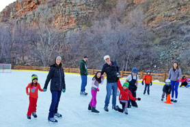 Families ice skating at the Outdoor Ice Rink at LaVern Johnson Park, Colorado.