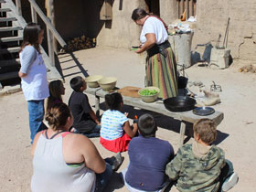 Living history cooking demonstration in front of a crowd at Bent's Old Fort Historic Site in La Junta, Colorado.