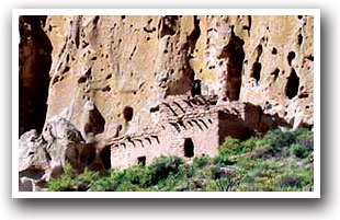 Ruins of a structure with cliff wall in background at Bandelier National Monument, New Mexico.