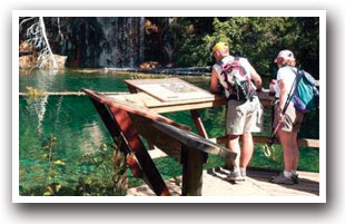 A couple reading the information board at Hanging Lake Trail, Colorado.