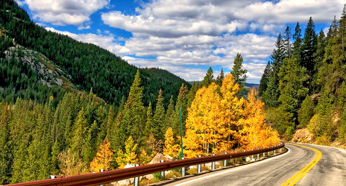 View along one of Colorado's Scenic Historic Byways in the fall with trees changing to fall colors.