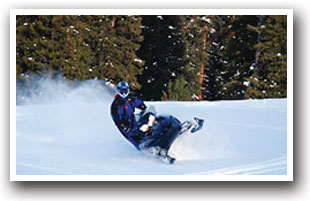 Snowmobile speeding across the snow near North Park and Walden, Colorado